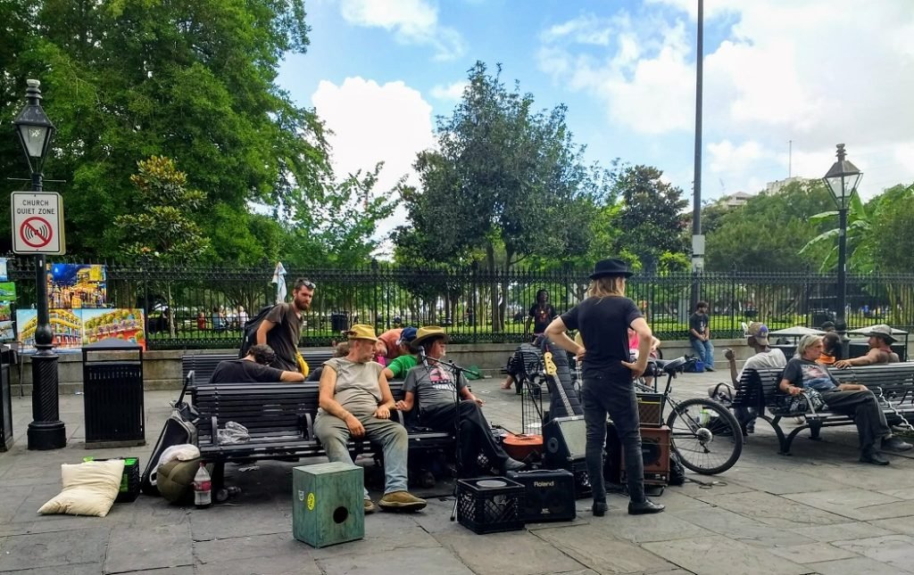 men lounging in Jackson Square New Orleans