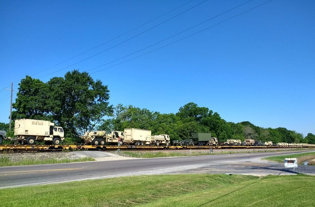 trucks on flatbed train cars