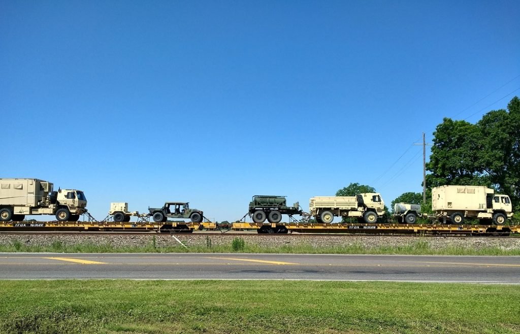 military trucks on train